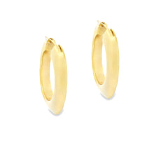 18k yellow gold hoop earrings from Tiffany & Co. The hoops are ...