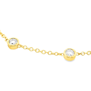 This beautiful 14k yellow gold bracelet features 5 bezel-set round ...