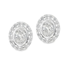 These beautiful 14k white gold earrings feature 2 oval cut diamonds...