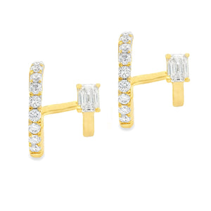 These small 14k yellow gold double hoop earrings feature a baguette...