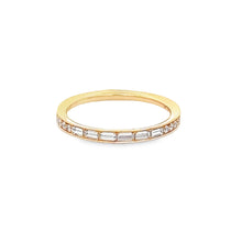 This 18k rose gold diamond band features channel set baguette and r...
