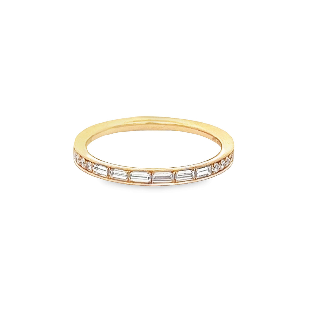 This 18k rose gold diamond band features channel set baguette and r...