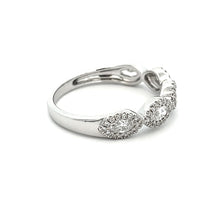 This stylish 14k white gold diamond band features round brilliant c...