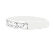 This beautiful 14k white gold diamond band features channel-set rou...