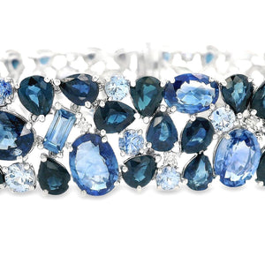 This stunning 18k white gold bracelet features various shades of bl...