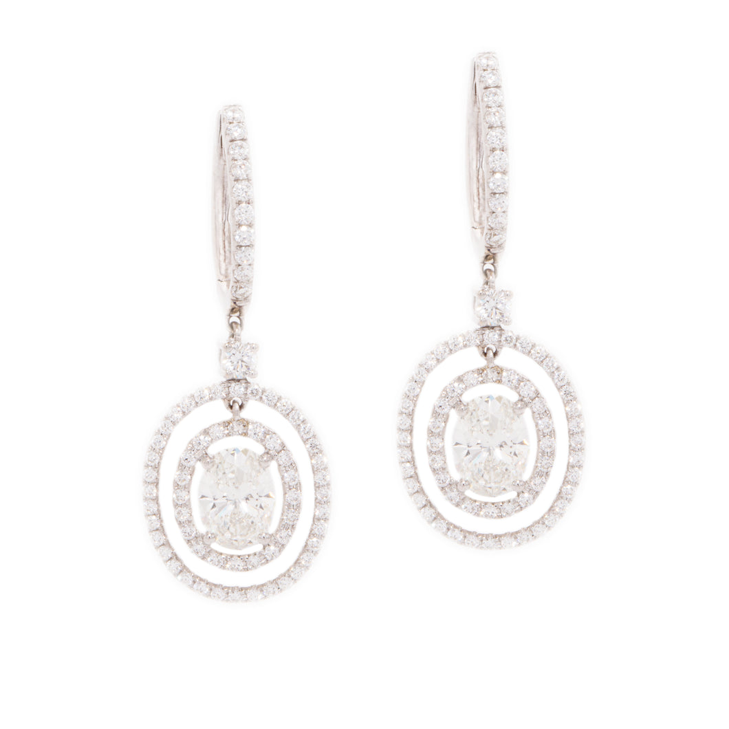 Estate piece. These gorgeous 18k white gold drop earrings feature l...