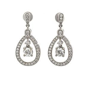 These gorgeous 14k white gold drop earrings feature 2 diamonds tota...