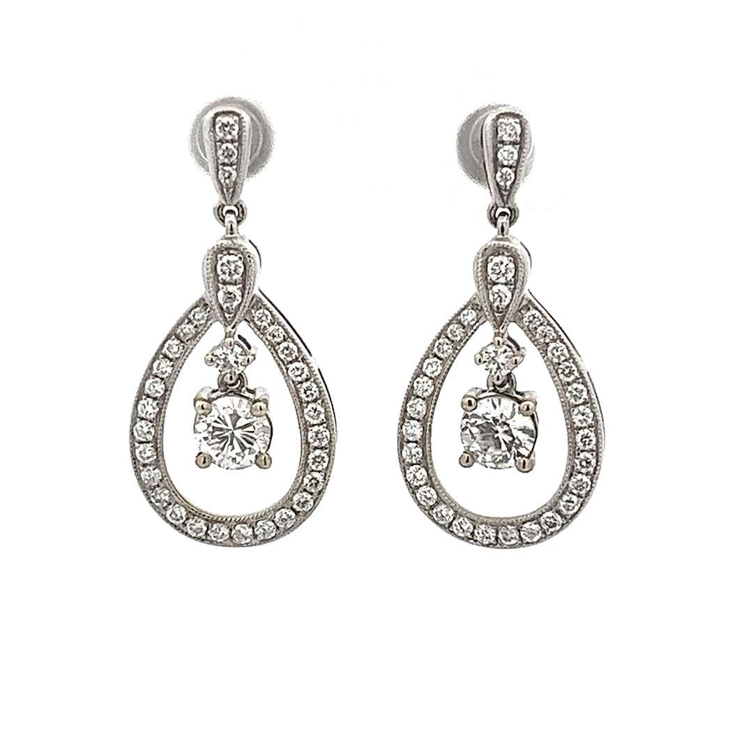These gorgeous 14k white gold drop earrings feature 2 diamonds tota...