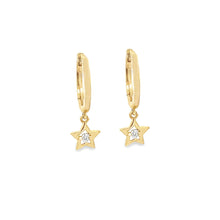These dainty 14k yellow gold huggy earrings features a star drop wi...