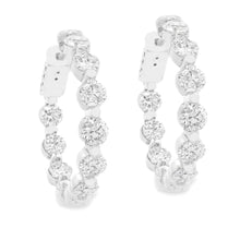 These beautiful diamond hoop earrings feature 20 round brilliant cu...