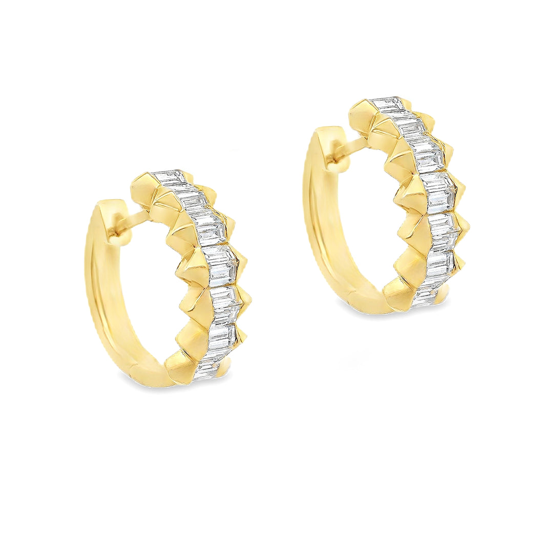 These 14k yellow gold huggy earrings feature 28 baguette cut diamon...