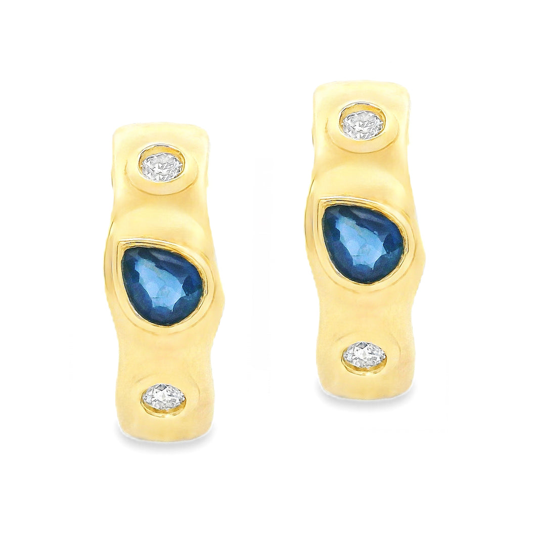 These dainty 14k yellow gold earrings feature 2 pear shaped sapphir...
