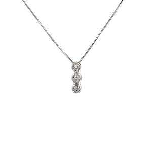 This 18k white gold bezel-set pendant features 3 round brilliant cu...