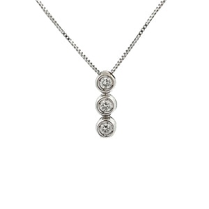 This 18k white gold bezel-set pendant features 3 round brilliant cu...