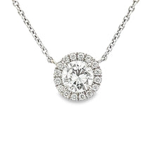 This beautiful 14k white gold pendant features a center round brill...