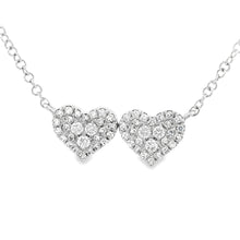 This 14k white gold double heart pendant features pave-set round br...