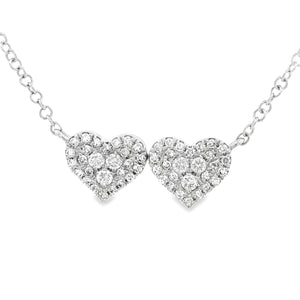 This 14k white gold double heart pendant features pave-set round br...
