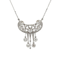 This elegant platinum necklace features round brilliant cut diamond...
