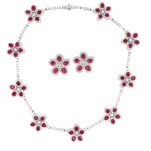 This stunning pair of earrings and necklace both feature rubies and...