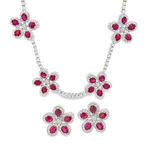 This stunning pair of earrings and necklace both feature rubies and...