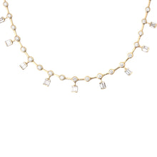 This stunning 18k yellow gold necklace features bezel-set round bri...