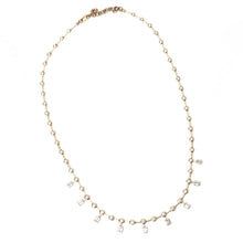 This stunning 18k yellow gold necklace features bezel-set round bri...