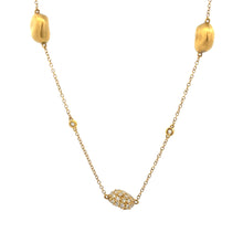 This 18k yellow gold necklace features pave set diamonds on the cen...