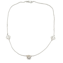 This 14k white gold necklace features 3 flowers with diamonds total...