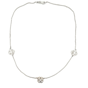 This 14k white gold necklace features 3 flowers with diamonds total...