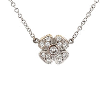 This 14k white gold necklace features 3 flowers with diamonds total...