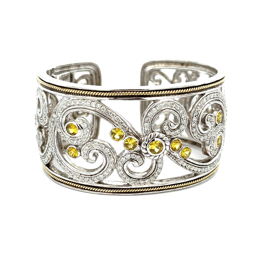 This elegant large bangle features pave-set round brilliant cut dia...