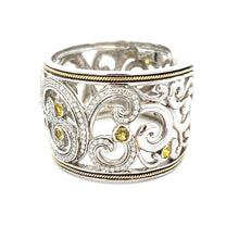 This elegant large bangle features pave-set round brilliant cut dia...