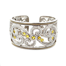 This elegant large bangle features pave-set round brilliant cut dia...