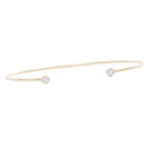 This 14k yellow gold cuff bangle features 2 bezel-set round brillia...