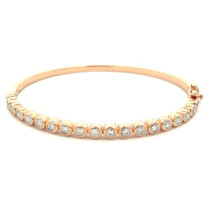 This 14k rose gold diamond bangle features 19 round brilliant cut d...