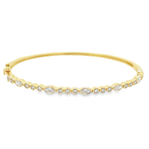 This easy to stack and style 14k yellow gold bangle features round ...