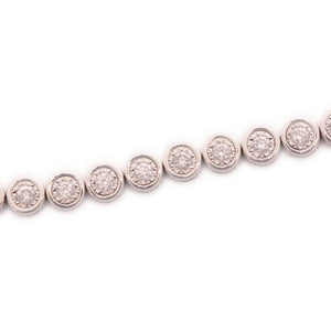 This 14k white gold diamond bracelet features bezel-set round brill...