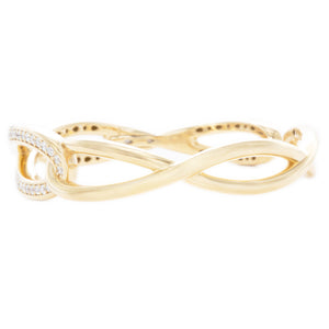 This beautiful 18k yellow gold cuff bangle features round brilliant...