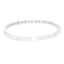 This stunning 18k white gold bangle features round brilliant cut di...