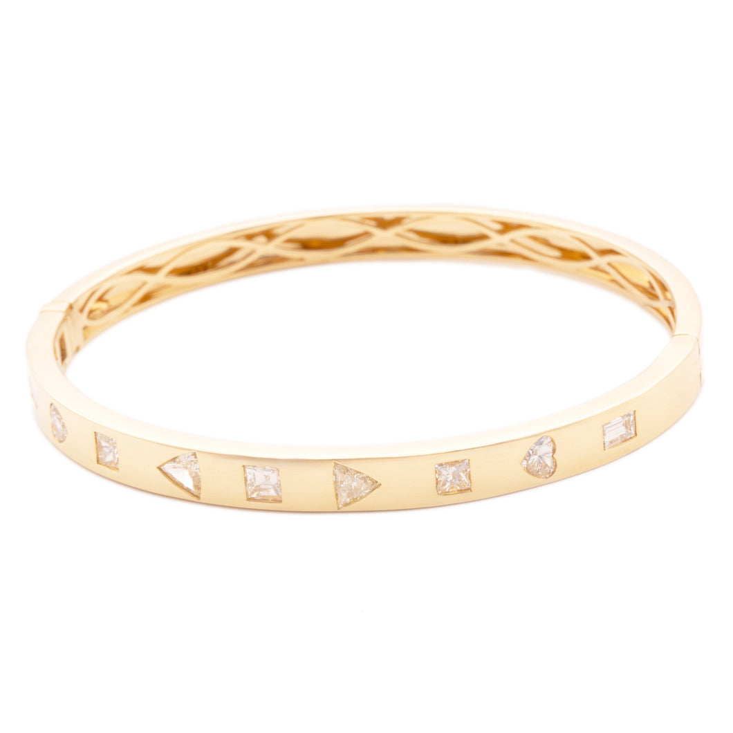 This 18k yellow gold bangle features 9 diamonds in various cuts and...