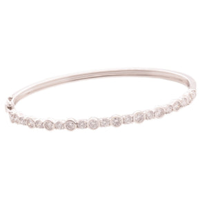 This easy to stack and style bangle features bezel-set round brilli...