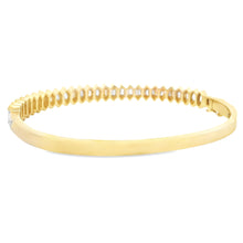 This beautiful 14k yellow gold bangle features 54 baguette cut diam...