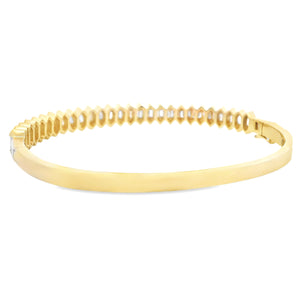 This beautiful 14k yellow gold bangle features 54 baguette cut diam...