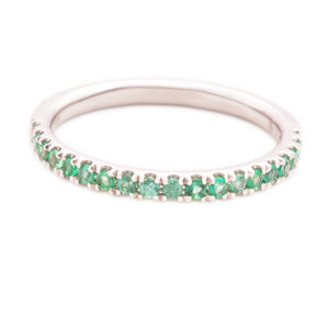 This 14k white gold band features emerald stones that wrap half way...