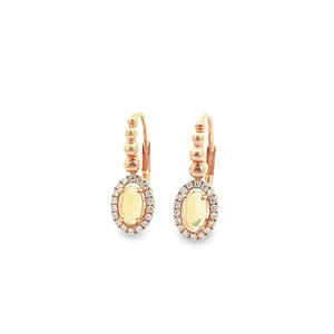These dainty 14k rose gold earrings features round brilliant cut di...