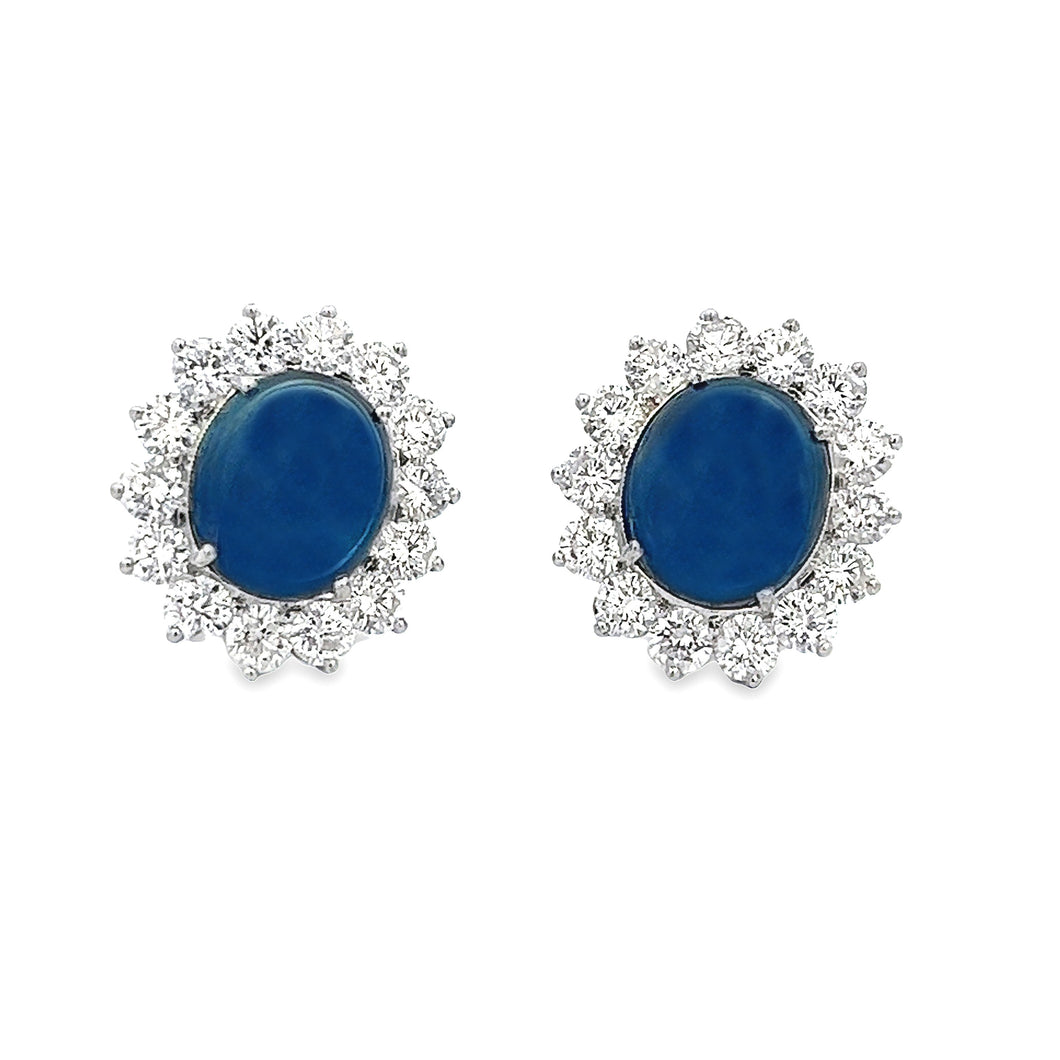 These 18k white gold earrings feature 2 cabochon sapphires totaling...