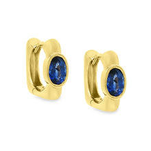 These beautiful 18k yellow gold huggy earrings feature 2 oval cut s...