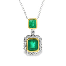 This beautiful 18k white/yellow gold pendant features 2 emeralds an...