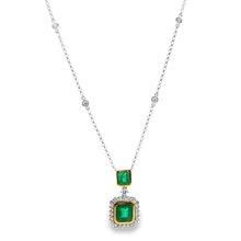 This beautiful 18k white/yellow gold pendant features 2 emeralds an...