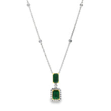 This beautiful 18k white/yellow gold pendant features 2 emeralds an...